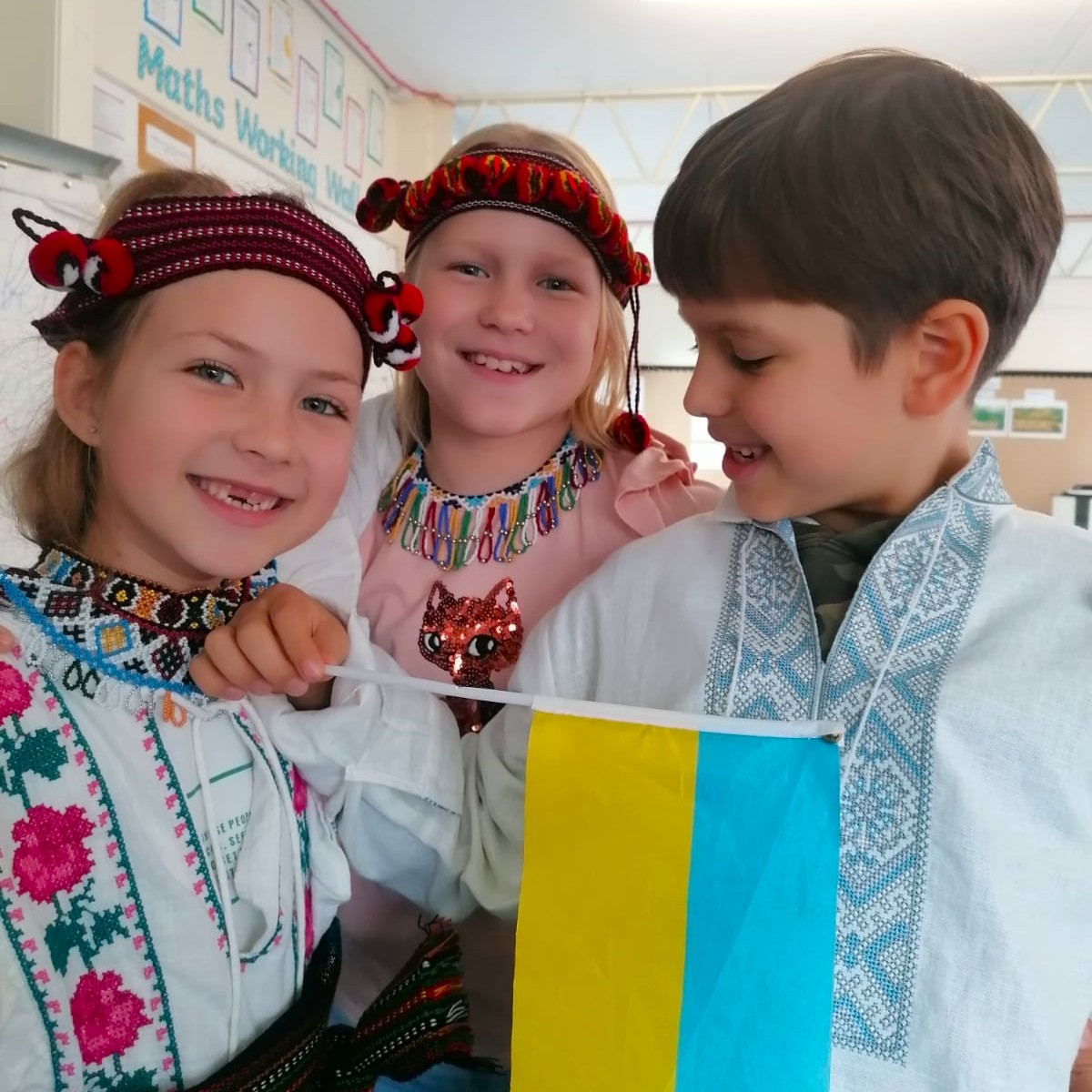 Діти у традиційних українських вишиванках з прапором України - втілення місії школи зі збереження культури